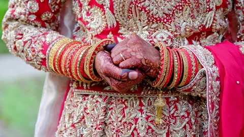 Bide is holding her hands, dressed in traditional red Indian clothes, Elements Video stock 310284521