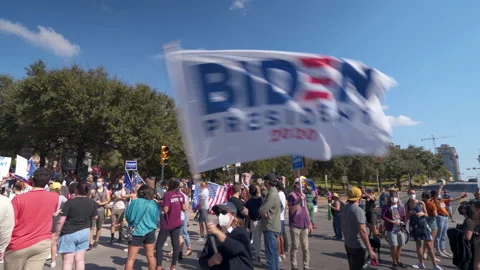 Biden supporter waves banner in post-election celebration in Austin, TX // Stock Footage