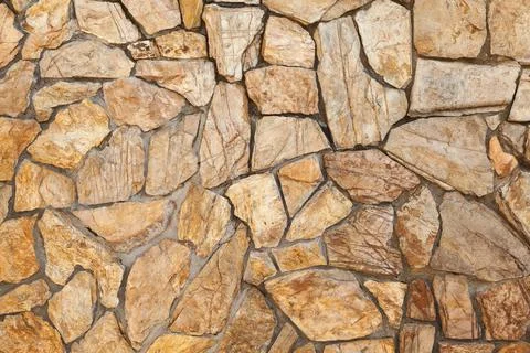 Biege stone wall pattern, frontal background texture Stock Photos