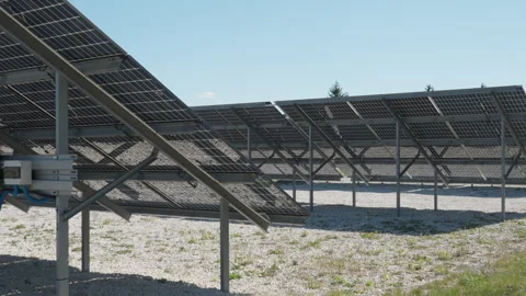Bifacial solar panel array on white gravel ground for sunlight reflection Stock Footage 334391027