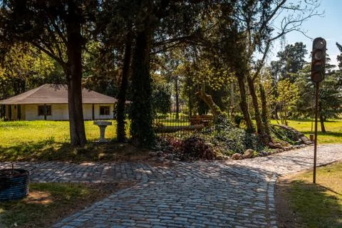 Bifurcation in a cobblestone park path with a broken, rusty and grungy street Stock Photos