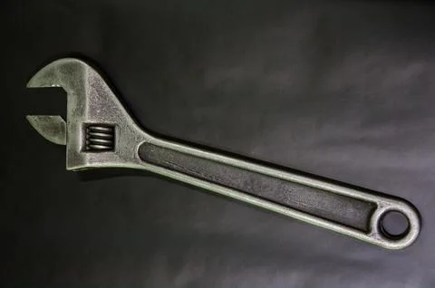 Big adjustable wrench on a black background. tool for the mechanic. close-up Stock Photos