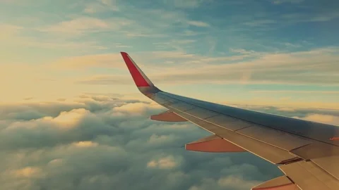 Big airplane wing window view flying above the clouds Stock Footage 278467833