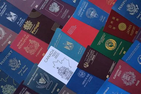 Big amount of passports of various different countries. Covers of expired Stock Photos