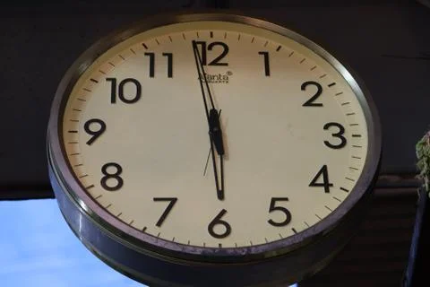 A big analog clock hung on the wall. Stock Photos