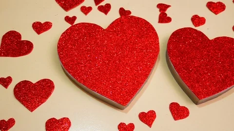 Big and small bright red scarlet hearts on a white background. One of the hearts Video stock 123219559
