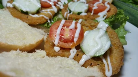 Big appetizing burger with chicken meat, vegetables, lettuce and mayonnaise sauc Stock Footage 157004527