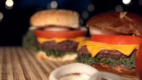 Big appetizing burger with meat cutlet, onion, vegetables, melted cheese and Stock Footage 116921765