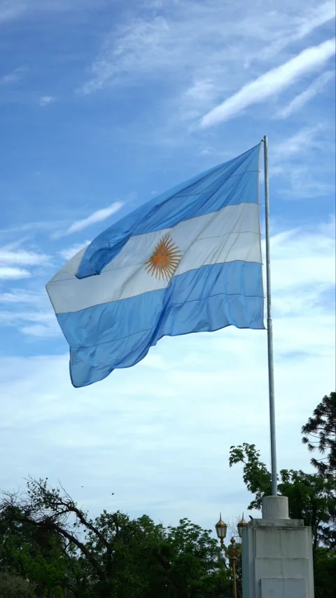 A big Argentine flag moving in the wind and a slightly cloudy sky behind. Stock Footage 294248185