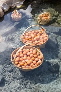 Big baskets of eggs boiled under hot water pond Foto stock