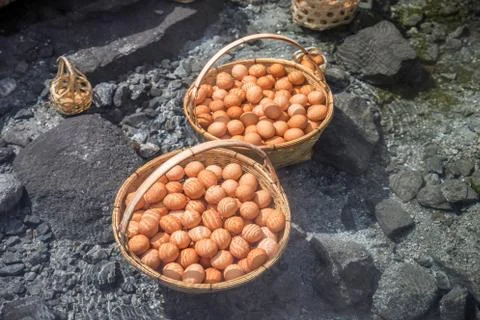 Big baskets of eggs boiled under hot water pond Stock Photos