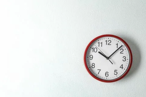 Big beautiful clock hanging on light background, space for text Foto stock