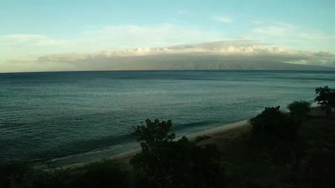 Big beautiful clouds above huge mountain at edge of ocean Stock Footage 163913122
