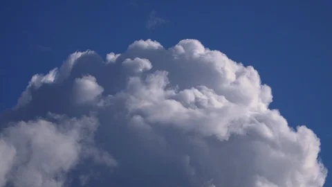 Big beautiful clouds are flying in the blue sky Stock Footage 105349181