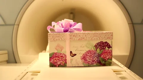 Big beautiful present gift box with violet pink ribbon bow sliding in tomography Stock Footage 132676226