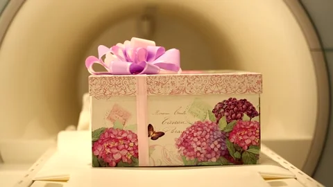 Big beautiful present gift box with violet pink ribbon bow sliding in medical ra Video stock 132676230
