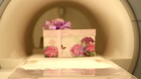 Big beautiful present gift box with violet pink ribbon bow sliding in tomography Stock Footage 132676232