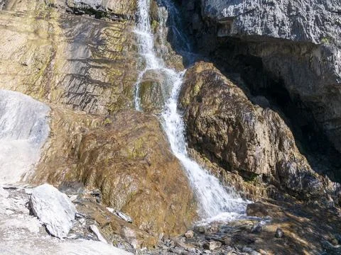 Big beautiful waterfall flows down the rocks mountains Stock Photos