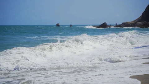 Big beautiful waves roll on an empty sandy beach. A strip of sandy beach.  Stock Footage 127902843