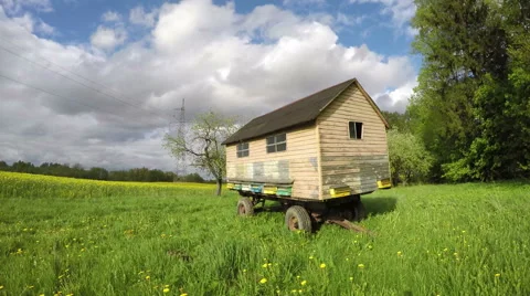 Big bee house  on spring farm field and clouds motion. Timelapse 4K Stock Footage 50151504