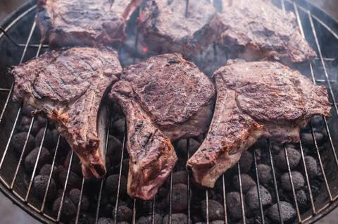 Big beef steaks on bone grilled  barbecue Photos