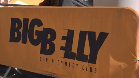 Big Belly Bar and Comedy Club Logo on Orange Barrier Stock Footage 345011560