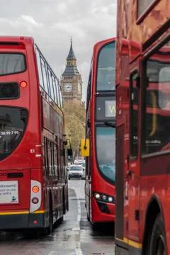 Big ben between 3 red london busses Stock Photos