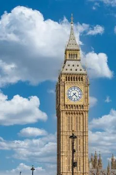 Big Ben clock tower against a blue sky with fluffy white clouds Stock Photos
