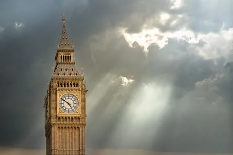 Big ben clock tower emerging from dramatic clouds in london Stock Photos