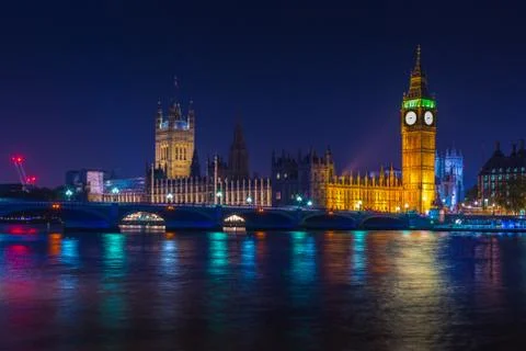 Big Ben clock tower on River Thames in Westminster, London at night. Long exp Stock Photos
