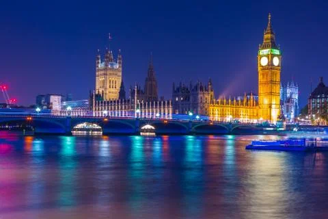 Big Ben clock tower on River Thames in Westminster, London at night. Long exp Stock Photos