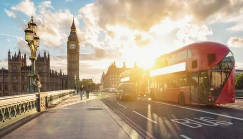 Big ben clock tower at sunset with red double decker bus, London Фото