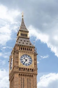Big Ben iconic clock tower bathed in daylight, emphasizing the golden accen.. Stock Photos