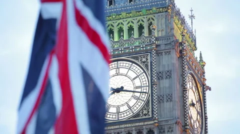 Big Ben tower clock in London with flag of United Kingdom waving in front Stock Footage 67678158