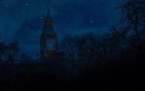 Big Ben tower at night under a starry sky with silhouette trees in foreground Stock Photos