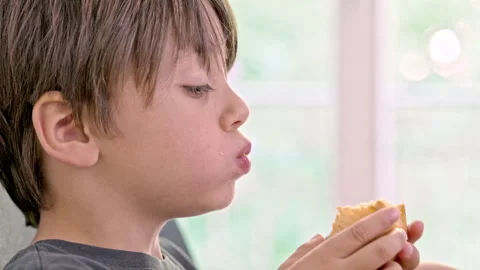 In A Big Bite, Little One Devours The Cake In His Hands And Dances With Joy Stock Footage 271236948