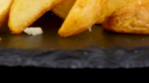 Big black burger with Fried Potato wedges, camera moves from bottom to top Stock Footage 84652316