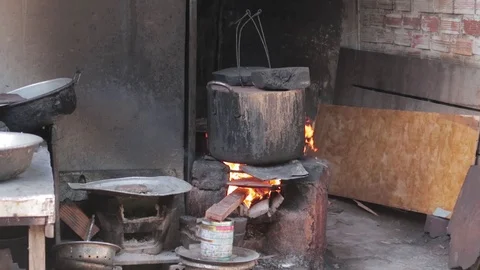Big Black cauldron is heated on an open fire. Video stock 118283117
