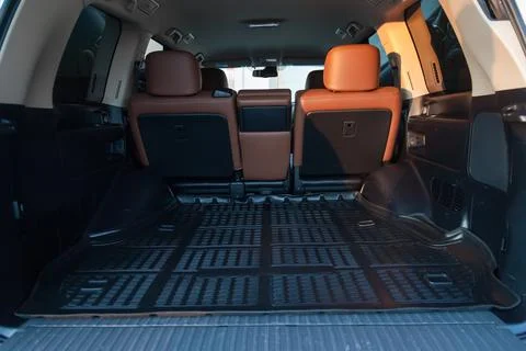 The big black empty trunk of SUV car with rubber mat and with leather folder  Foto stock
