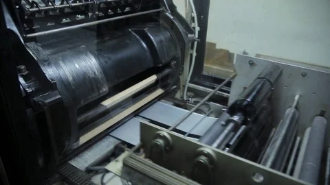 Big black printing machine working in modern printing house. Equipment for press Stock Footage 98561104