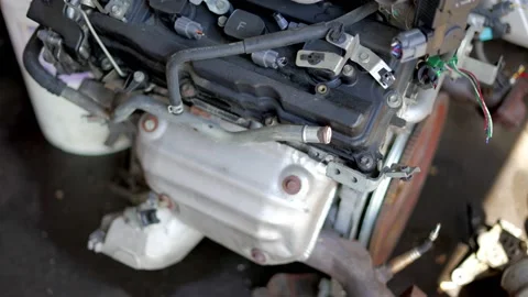 Big block engine V8 or V6 4 cylinder sitting on concrete ground floor in Stock Footage 156386024