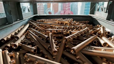 Big blue industrial bin loaded with brass pipe blanks. Logistics and storage of Stock Footage 329310759
