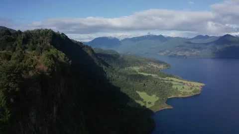Big blue lake between green mountains Stock Footage 249467576