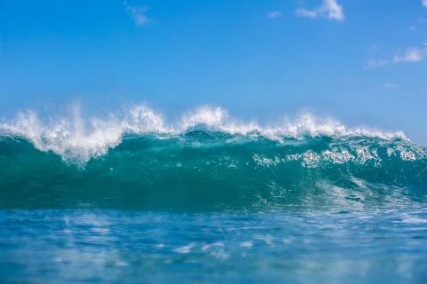 Big blue ocean powerful wave crashing against blue sky, closeup view from wat Stock Photos