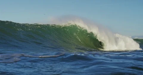 Big Blue Ocean Wave Breaking in Slow Motion 4K in dangerous shallow water Stock Footage 81598874
