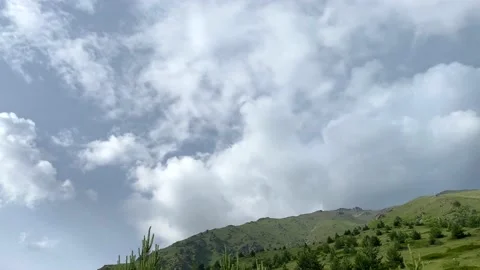Big blue sky with white clouds. Green rocky slopes Stock Footage 135323236