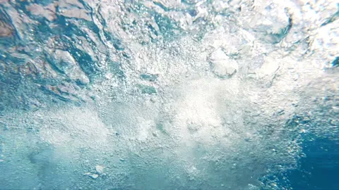 Big blue underwater bubbles rising to surface in slow motion Stock Footage 88343628