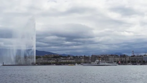 Big boat passing the Geneva city and Jet d'Eau fountain in Geneva lake Stock Footage