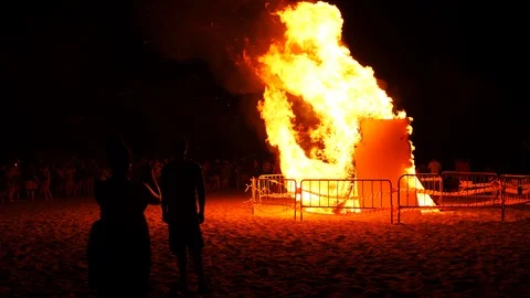 Big bonfire on the beach at night in honor of the fireworks festival Stock Footage 112262833