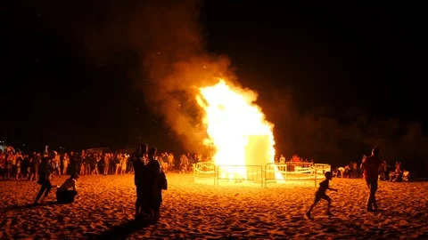 Big bonfire on the beach at night in honor of the fireworks festival. Stock Footage 112262848
